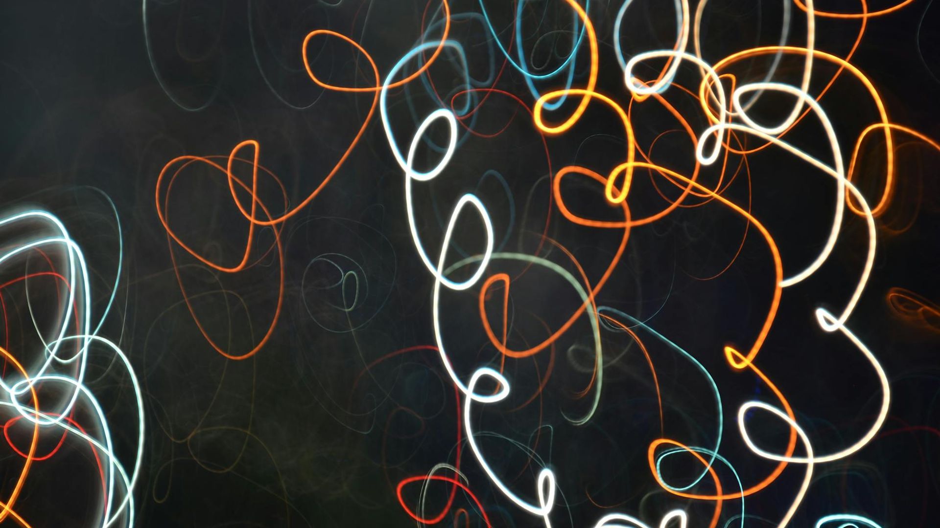 Abstract background image showing calm, flowing lines of light.